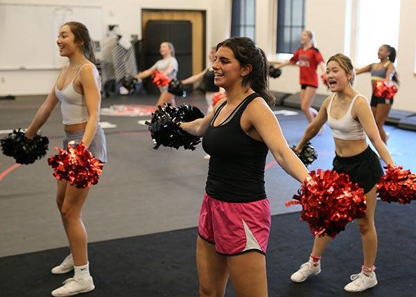 Cheer team practices in a gym